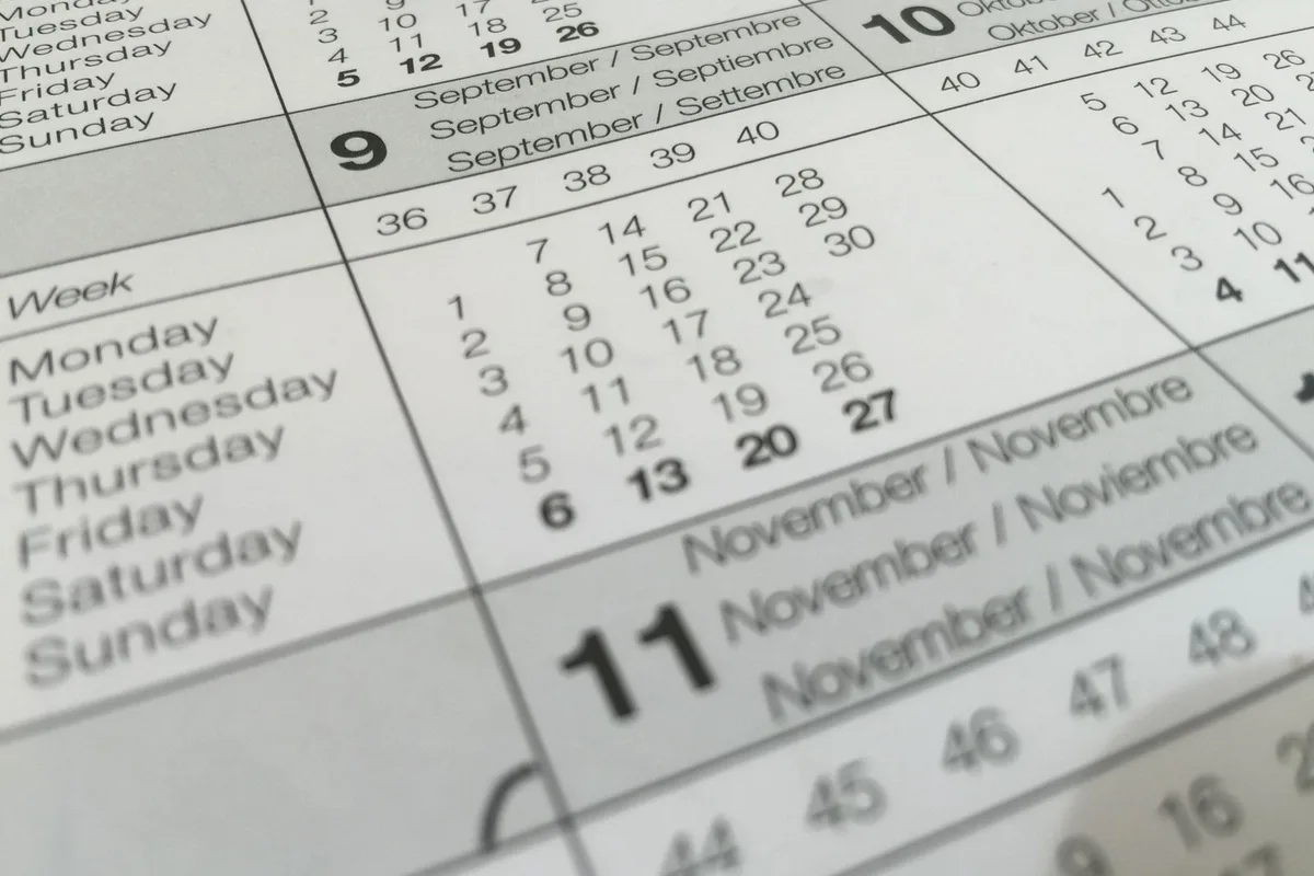 A wall planner open to September, with the month printed in English, Spanish, German and Italian
